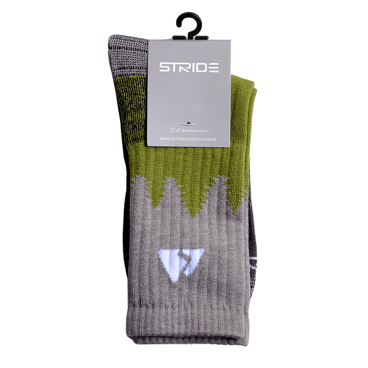 Grey and green upside down tree line merino wool socks with a grey tag and white stride brand writing and a black hanging hook 